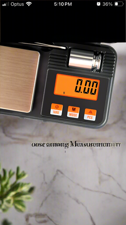 Digital weighted kitchen scale with precise measurements and orange backlit display